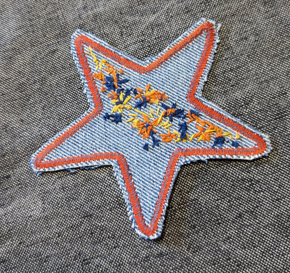 A star embroidered on a piece of denim.