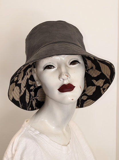 A mannequin wearing a hat with leaves on it.
