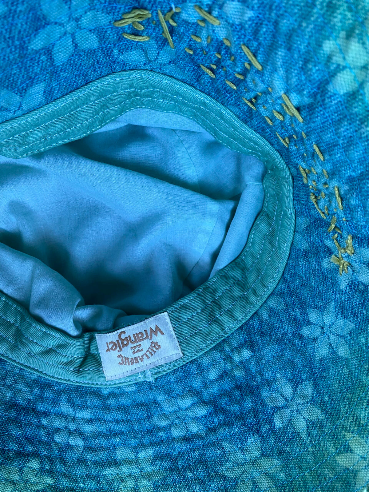 A close up of a blue hat with a label on it.