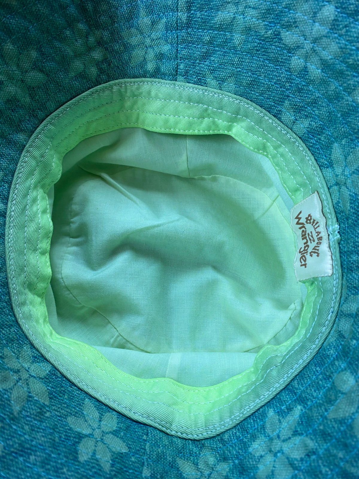 A blue and green hat with a label on it.