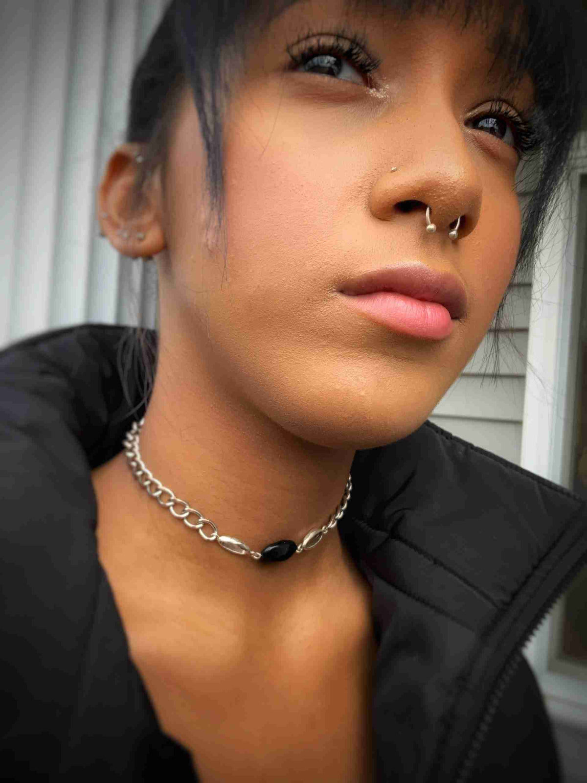 a close up of a person wearing a choker.