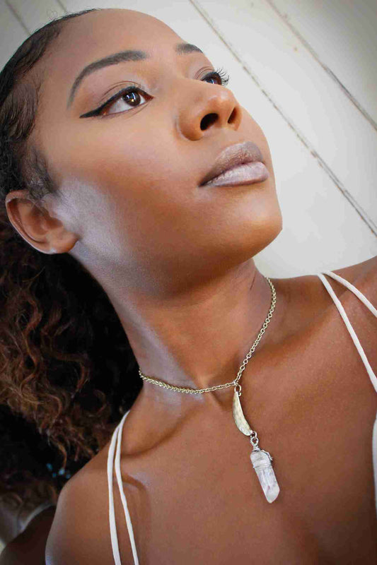 a woman with a necklace on her neck.