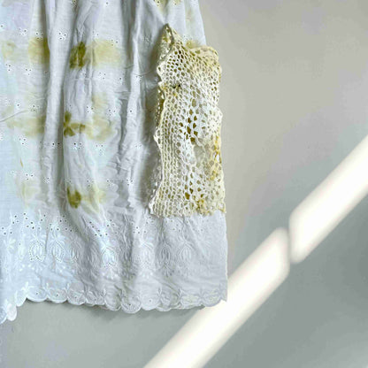 a piece of crochet is hanging on a wall.
