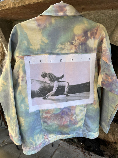 A tie dye denim jacket with a photo on it.
