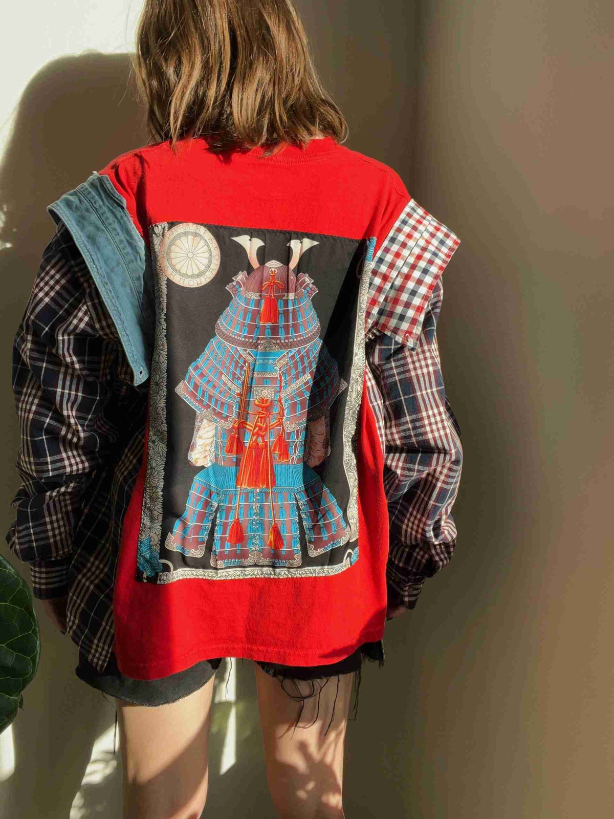 the back of a woman's jacket with an image of a woman wearing a.