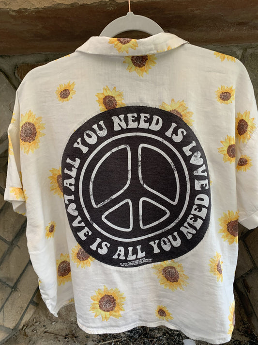 A white "All You Need Is Love" sunflower button-up shirt.