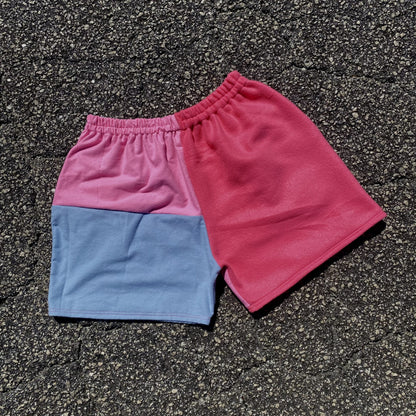 A pair of Cotton Candy Nike shorts laying on the ground.
