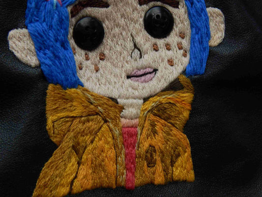 a close up of a stuffed animal wearing a jacket.