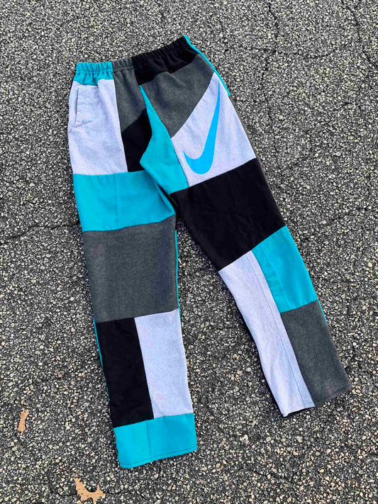 a pair of nike pants laying on the ground.