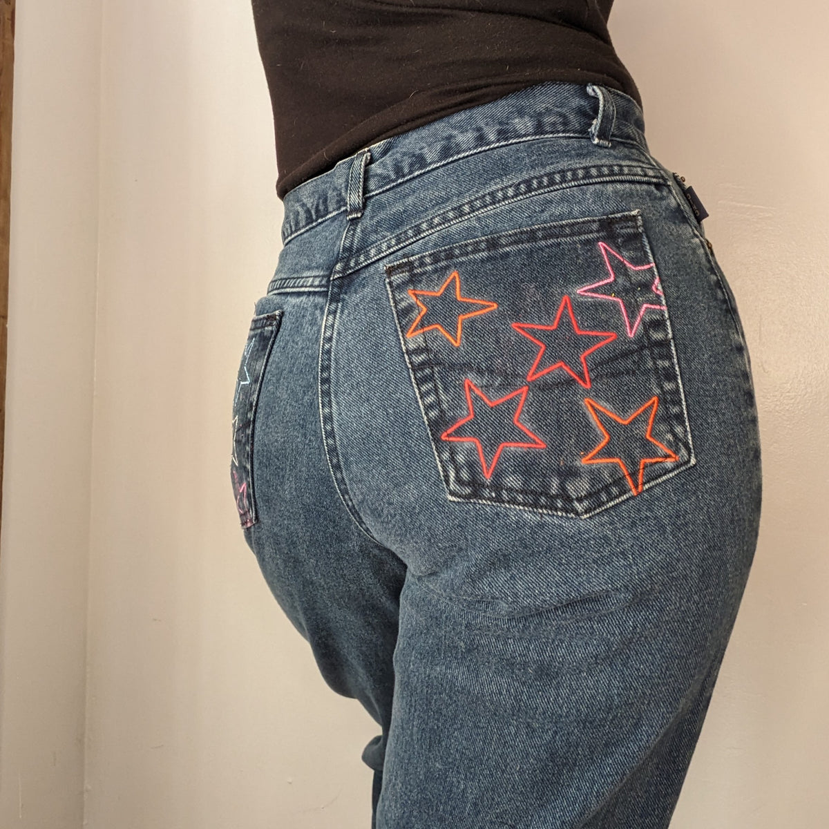 Rainbow Star Jeans with stars painted on them.