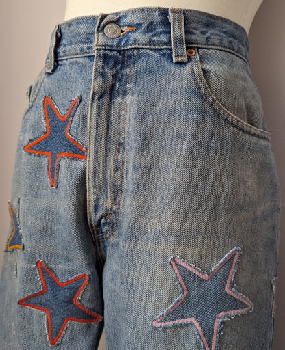A pair of jeans with stars embroidered on them.