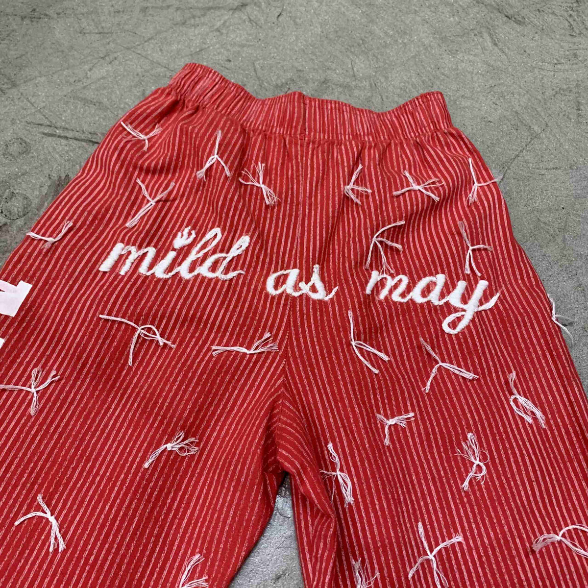 a pair of red shorts with white writing on them.