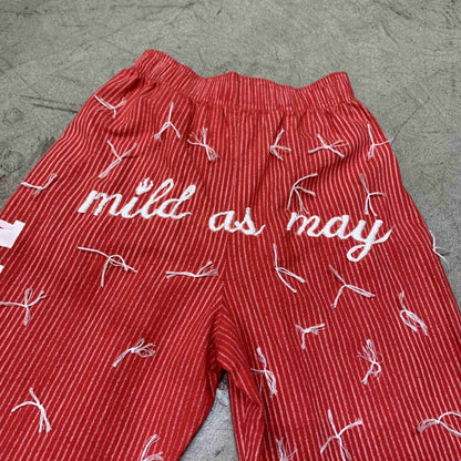 a pair of red shorts with white writing on them.