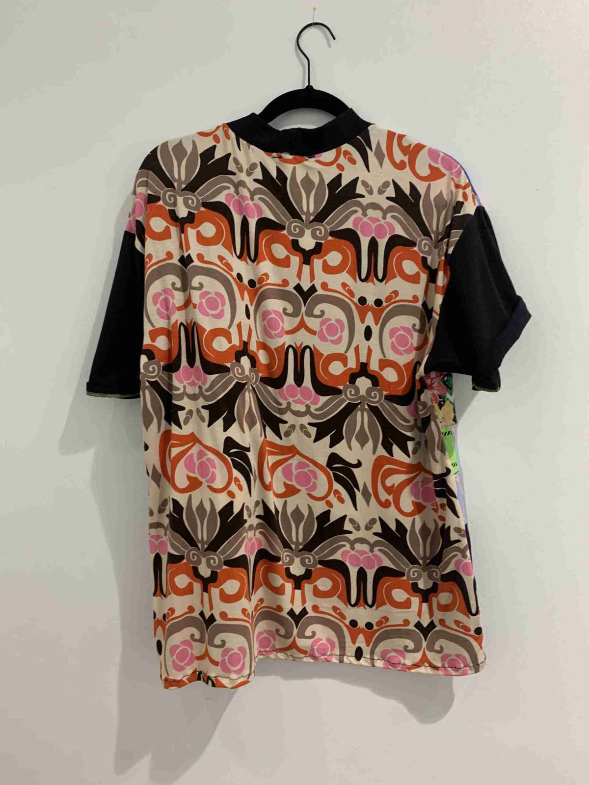 a t - shirt hanging up on a wall.