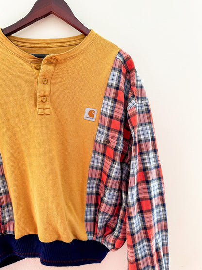 A yellow and blue plaid shirt hanging on a hanger.
