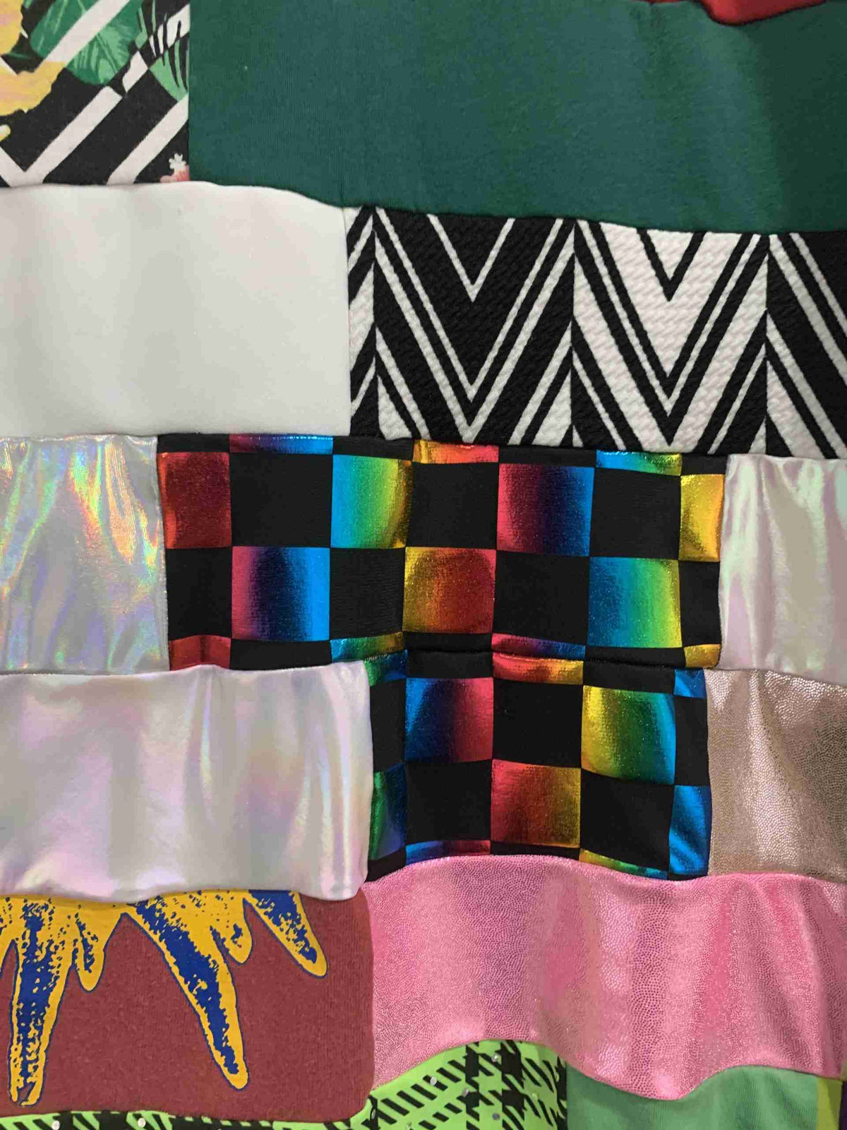 a close up of a quilt with many different colors.