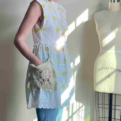 a woman standing next to a mannequin holding a purse.