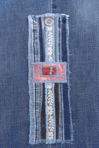 An upcycled denim cuff bracelet with dragonfly charm.