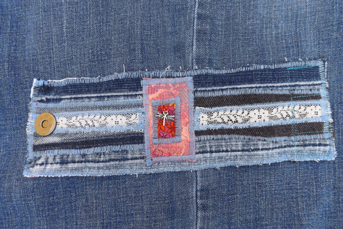 An upcycled denim cuff bracelet with dragonfly charm.