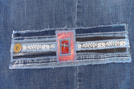 An upcycled denim cuff bracelet with dragonfly charm.