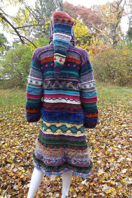 A full length crochet coat with elf hood in vibrant colors and mixed fibers.