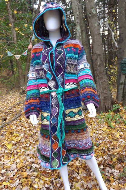 A unique long crochet coat with attached elf hood and removable belt.