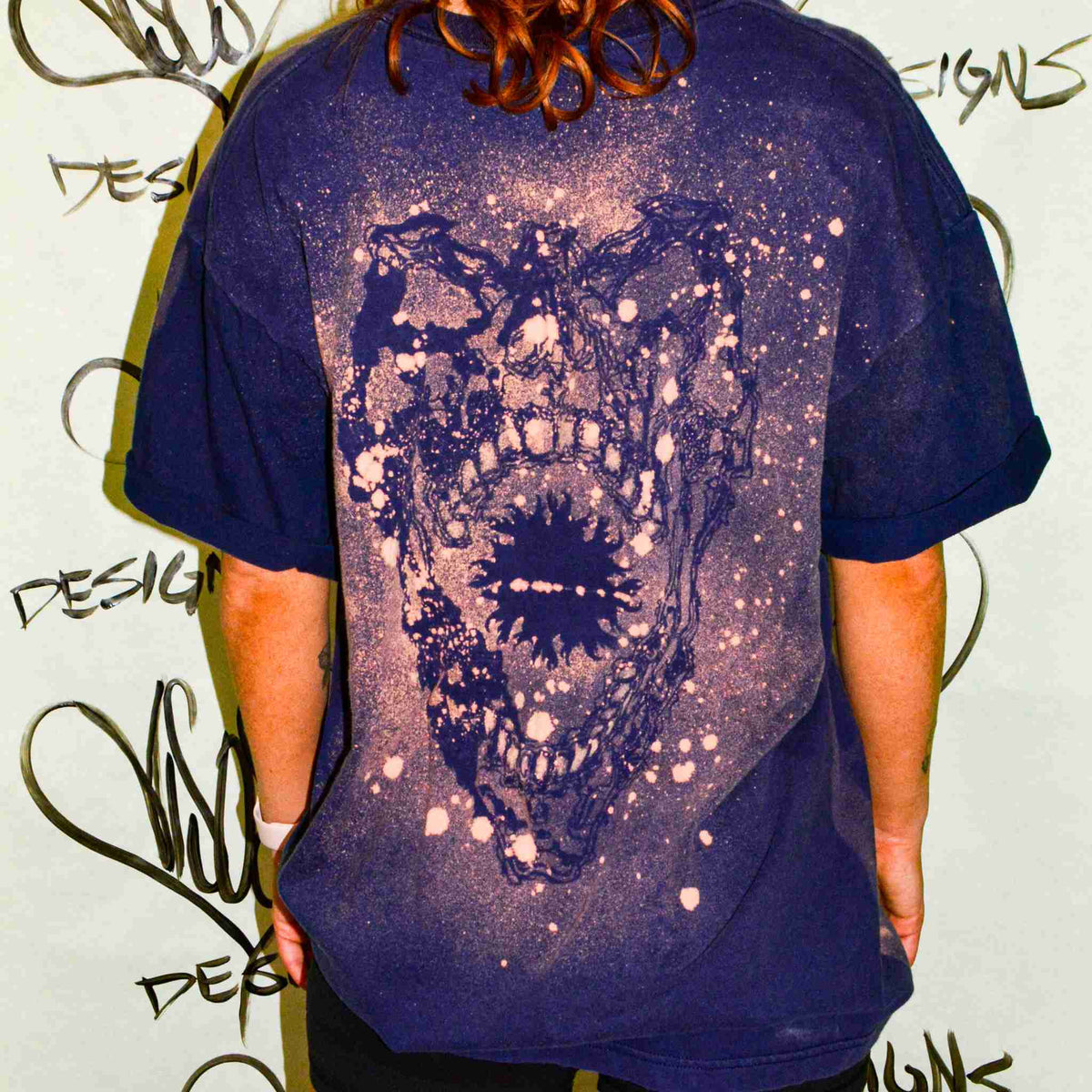 a man wearing a t - shirt with a picture of a bear on it.