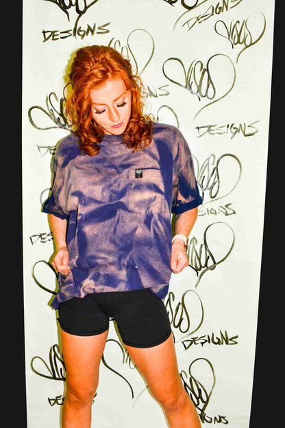 a woman standing in front of a wall with writing on it.
