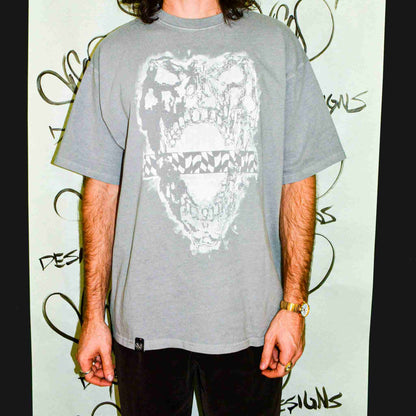 a man standing in front of a wall with graffiti on it.