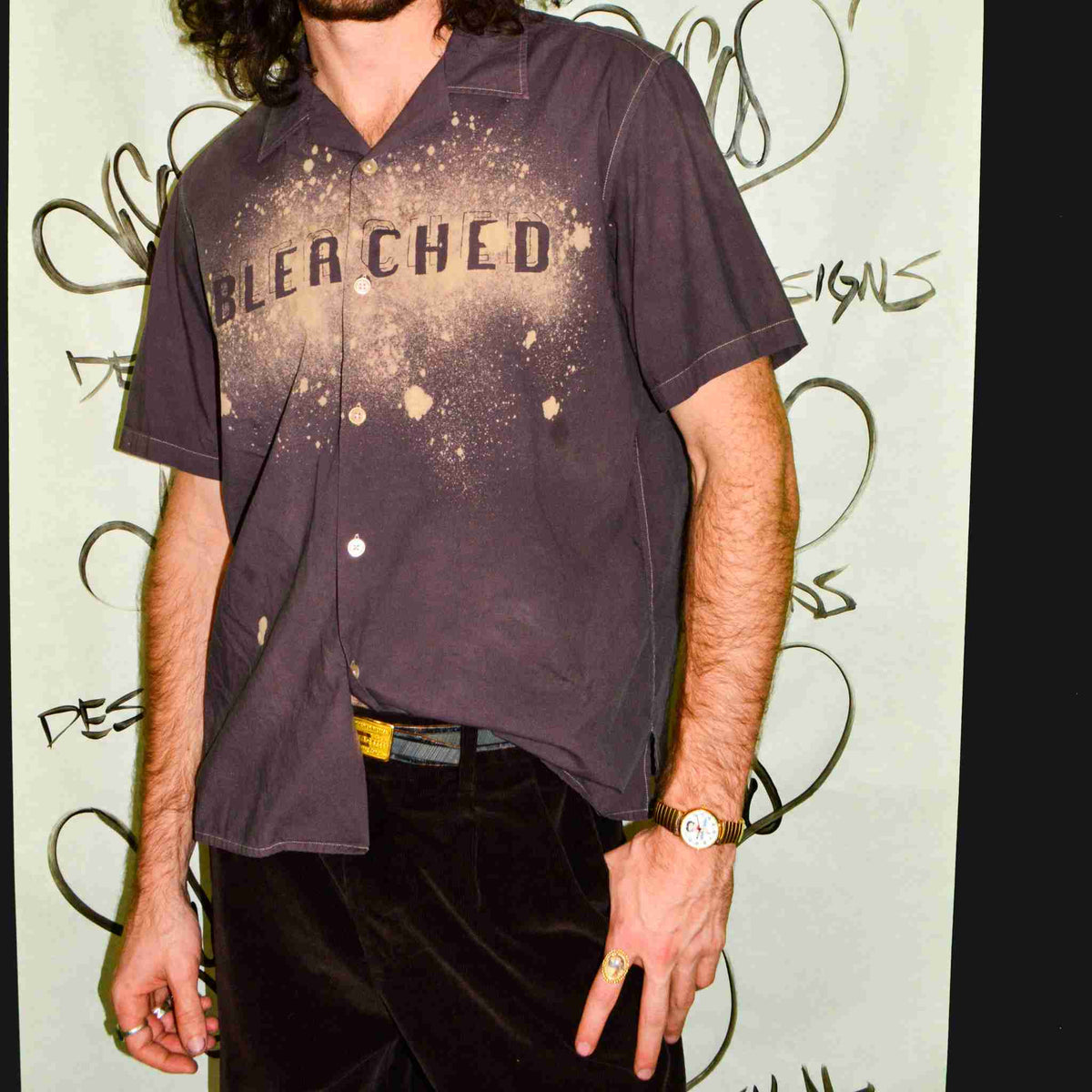 a man with long hair wearing a black shirt.