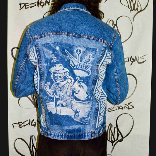 a person wearing a jean jacket with a picture on it.