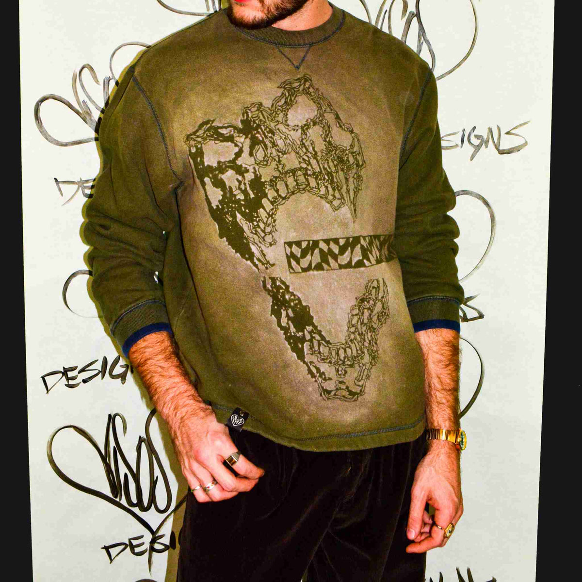 a man with a beard wearing a green shirt.