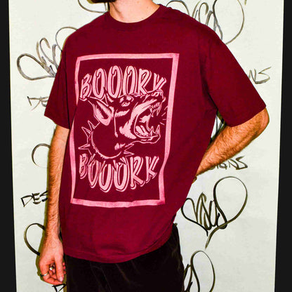 a man standing in front of a wall covered in graffiti.