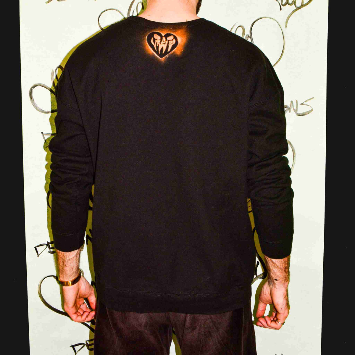 a man with a heart tattoo on his back.