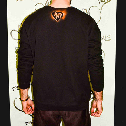 a man with a heart tattoo on his back.