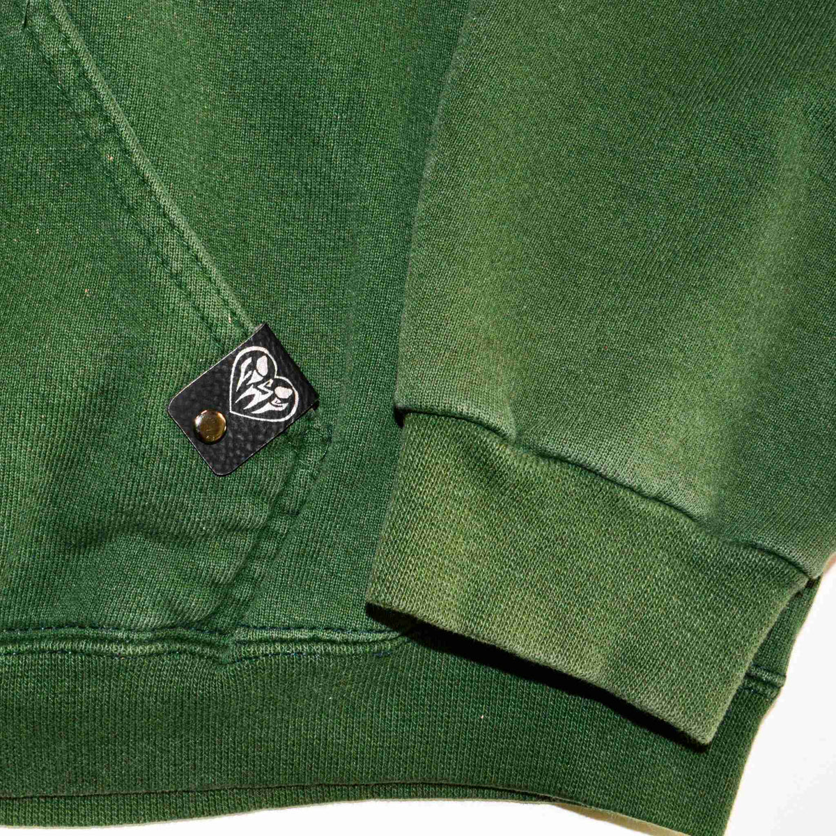 a close up of a green shirt with a badge on it.