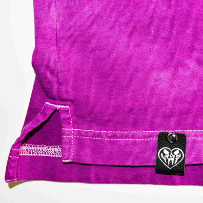a close up of a purple bag with a tag on it.
