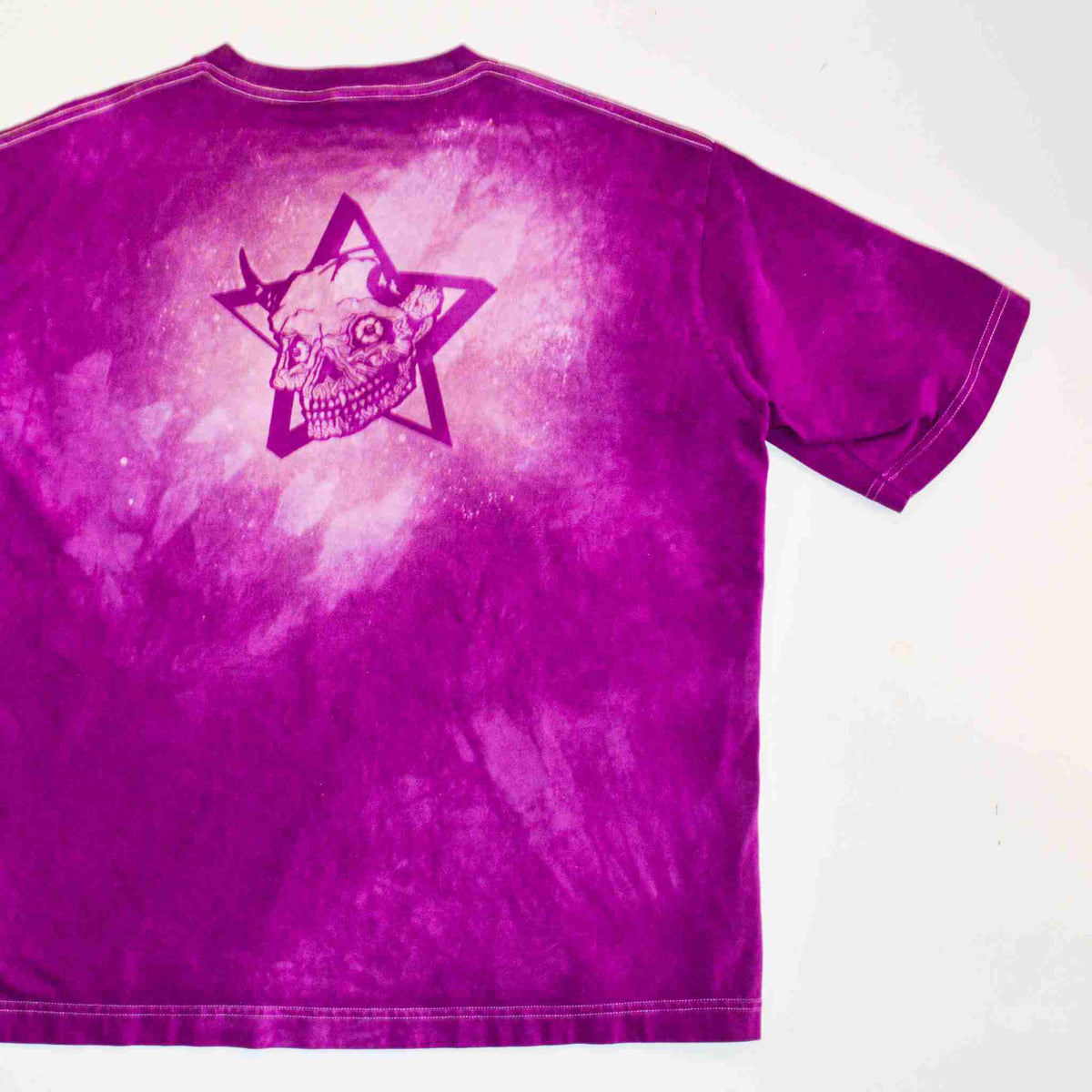 a purple shirt with a skull and star on it.