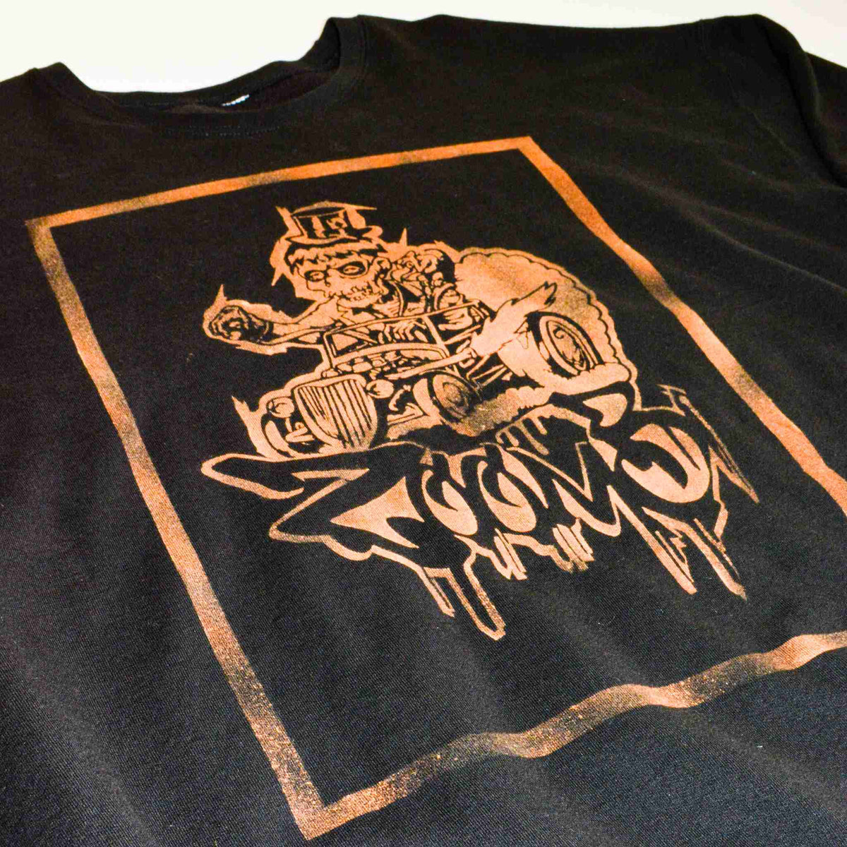 a t - shirt with a picture of a man riding a motorcycle.