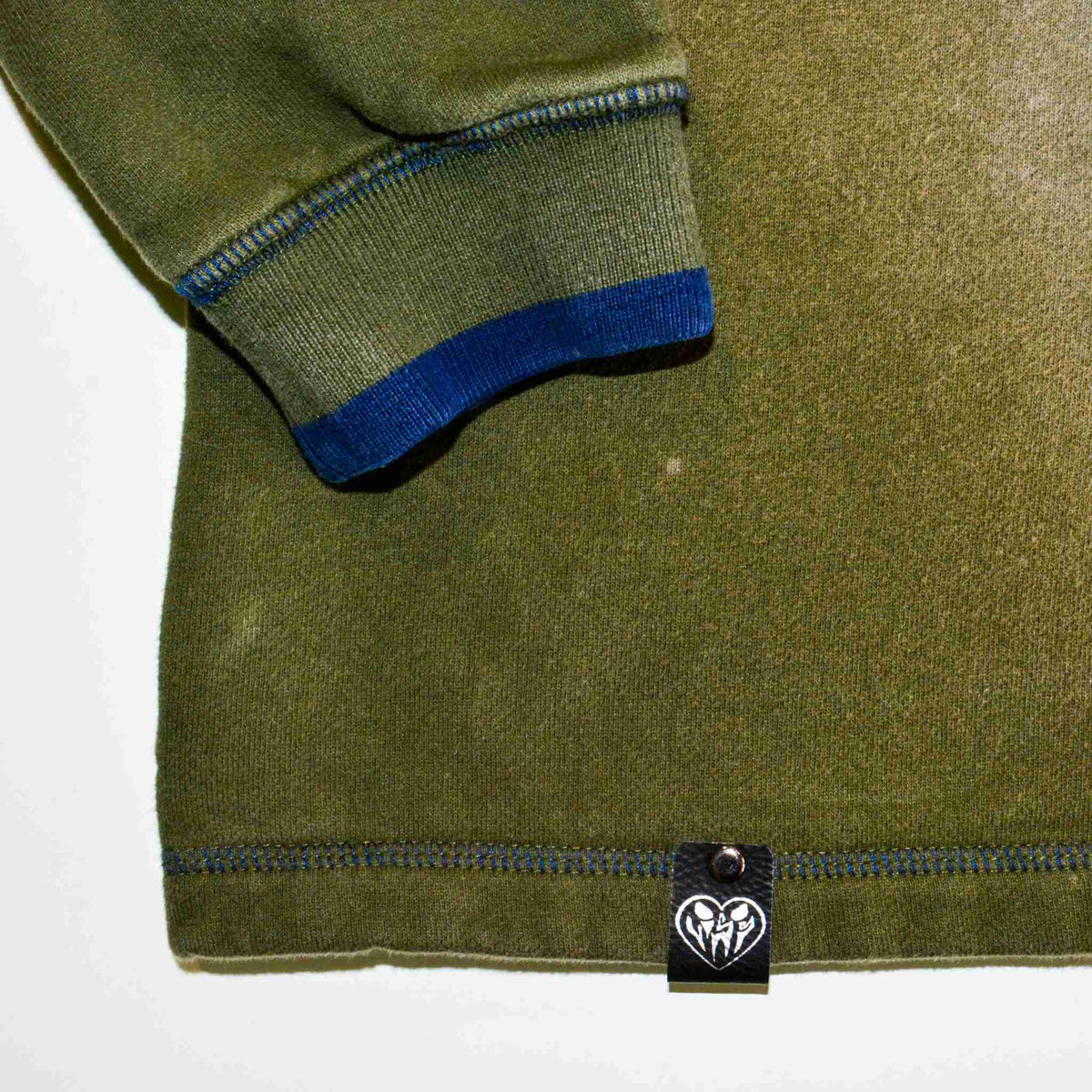 a green jacket with a blue stripe on it.