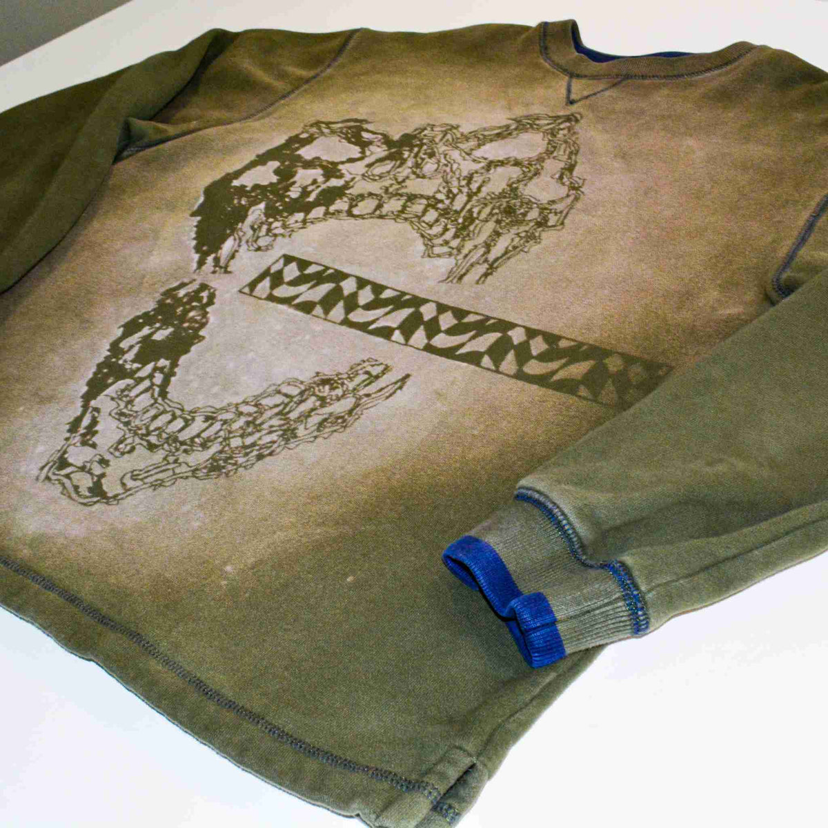a pair of jeans laying on top of a shirt.