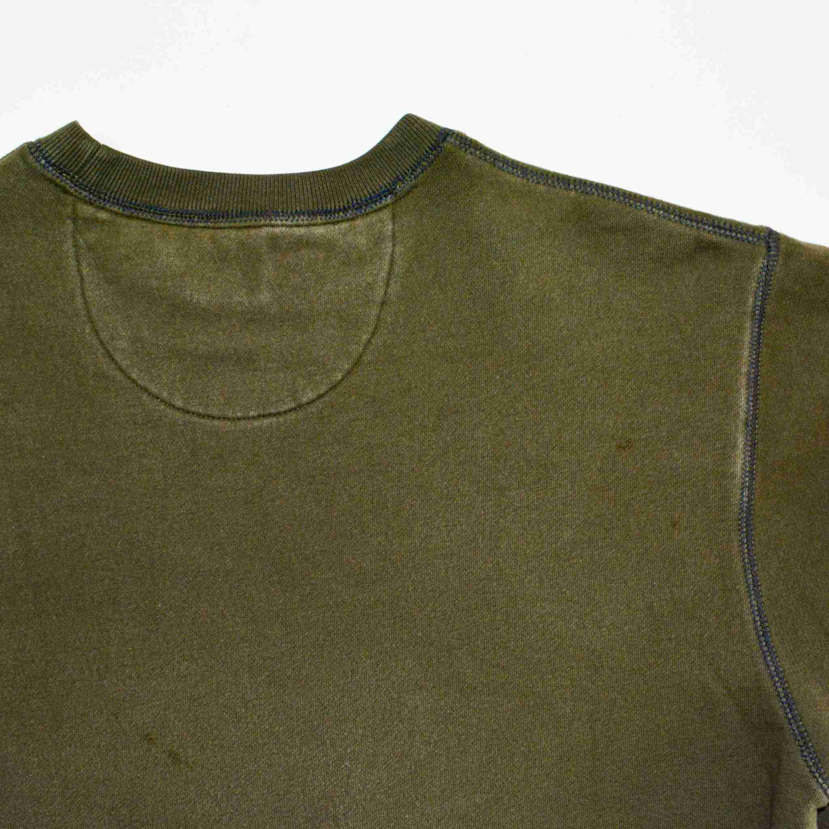 a close up of a green shirt with a white background.