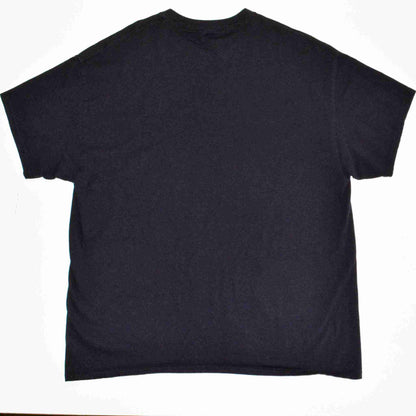 a black t - shirt sitting on top of a table.
