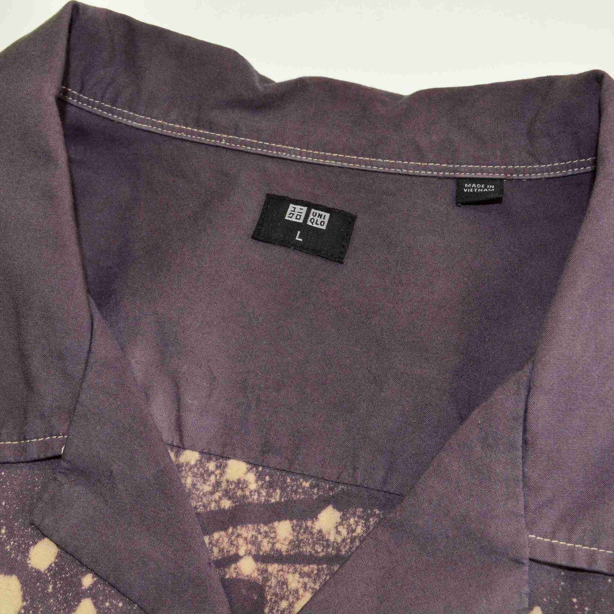 a close up of a shirt with a tag on it.