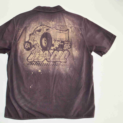 a brown shirt with a drawing of a train on it.