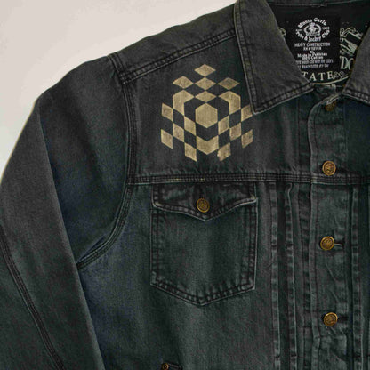 a black jean jacket with a checkered design on it.