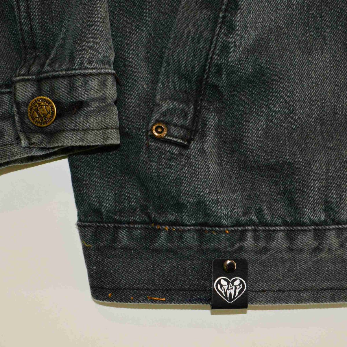 a close up of a jacket with a tag on it.