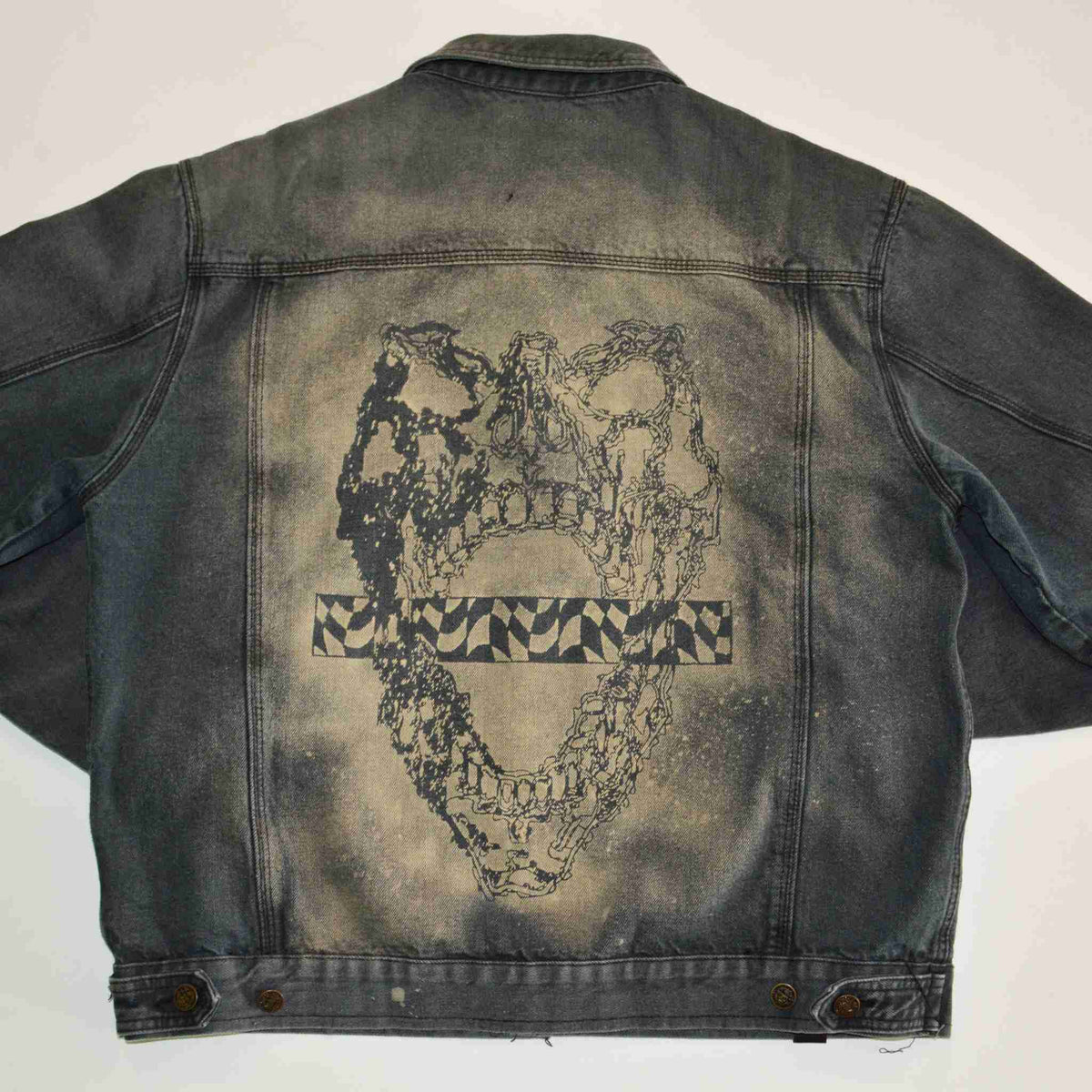 a denim jacket with a picture of a heart on it.