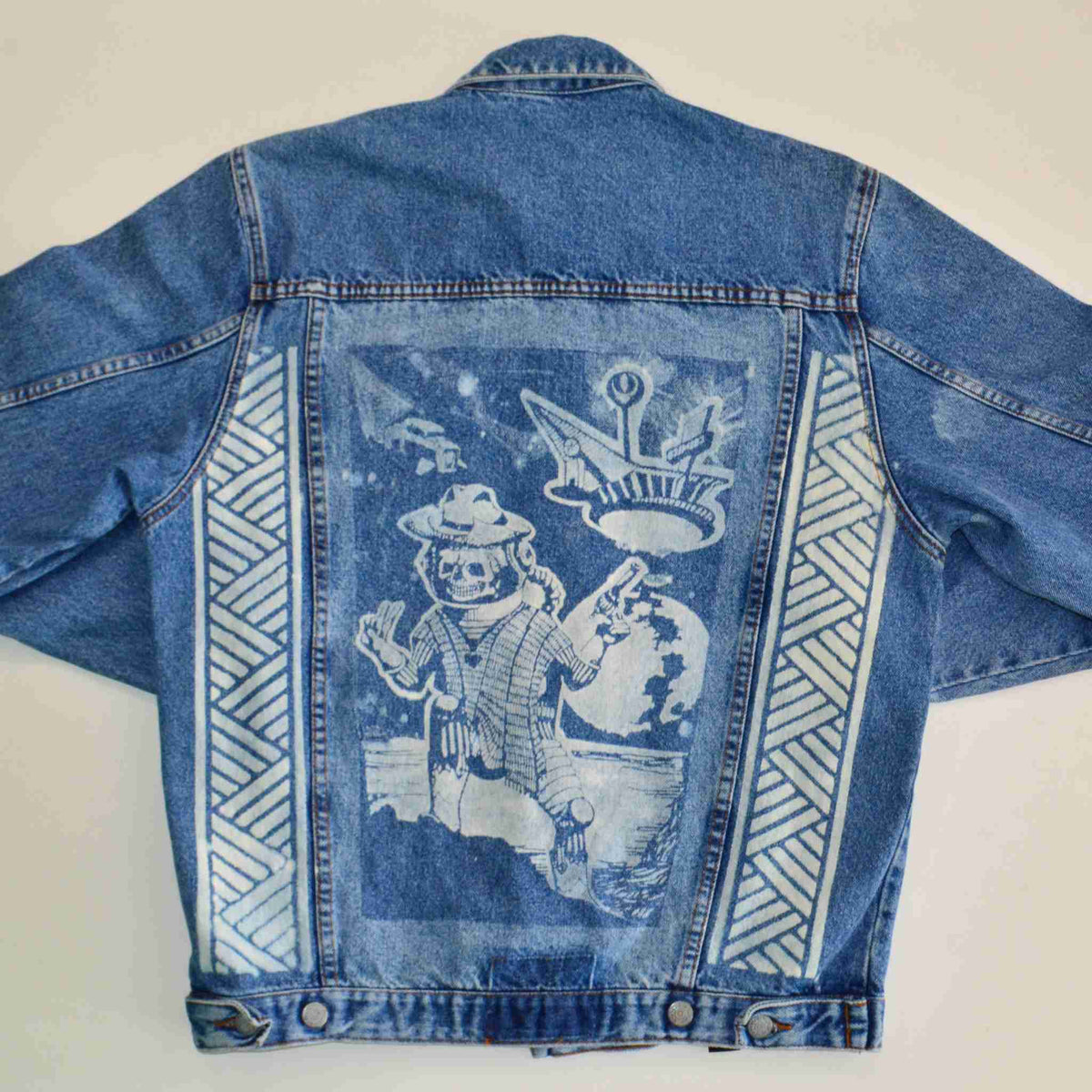 a blue jean jacket with a picture of a man on it.