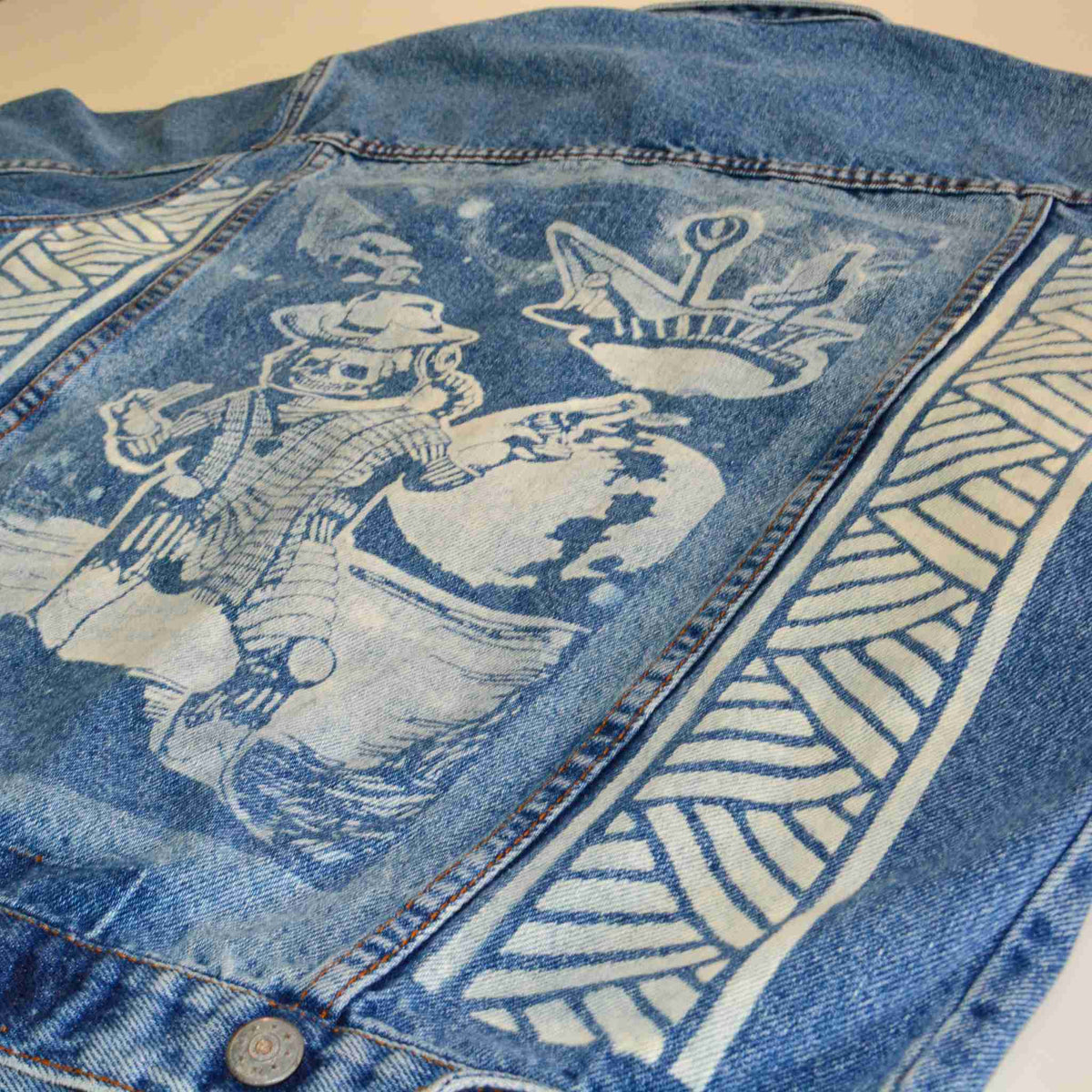 a blue jean jacket with a picture of a man on it.